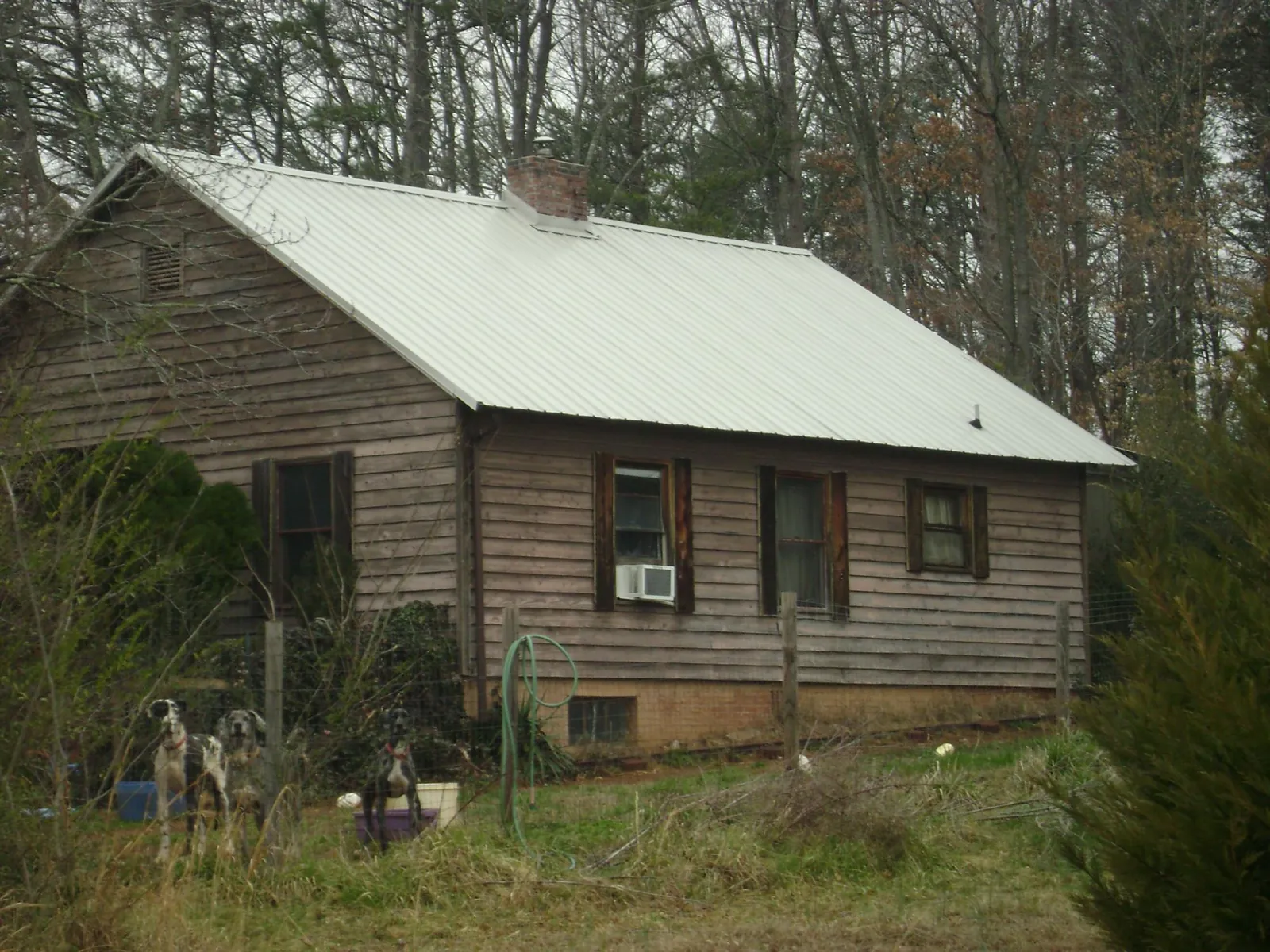 White metal roof on an old wood sided farmhouse, from a Metal Roof Installation job in Newburgh